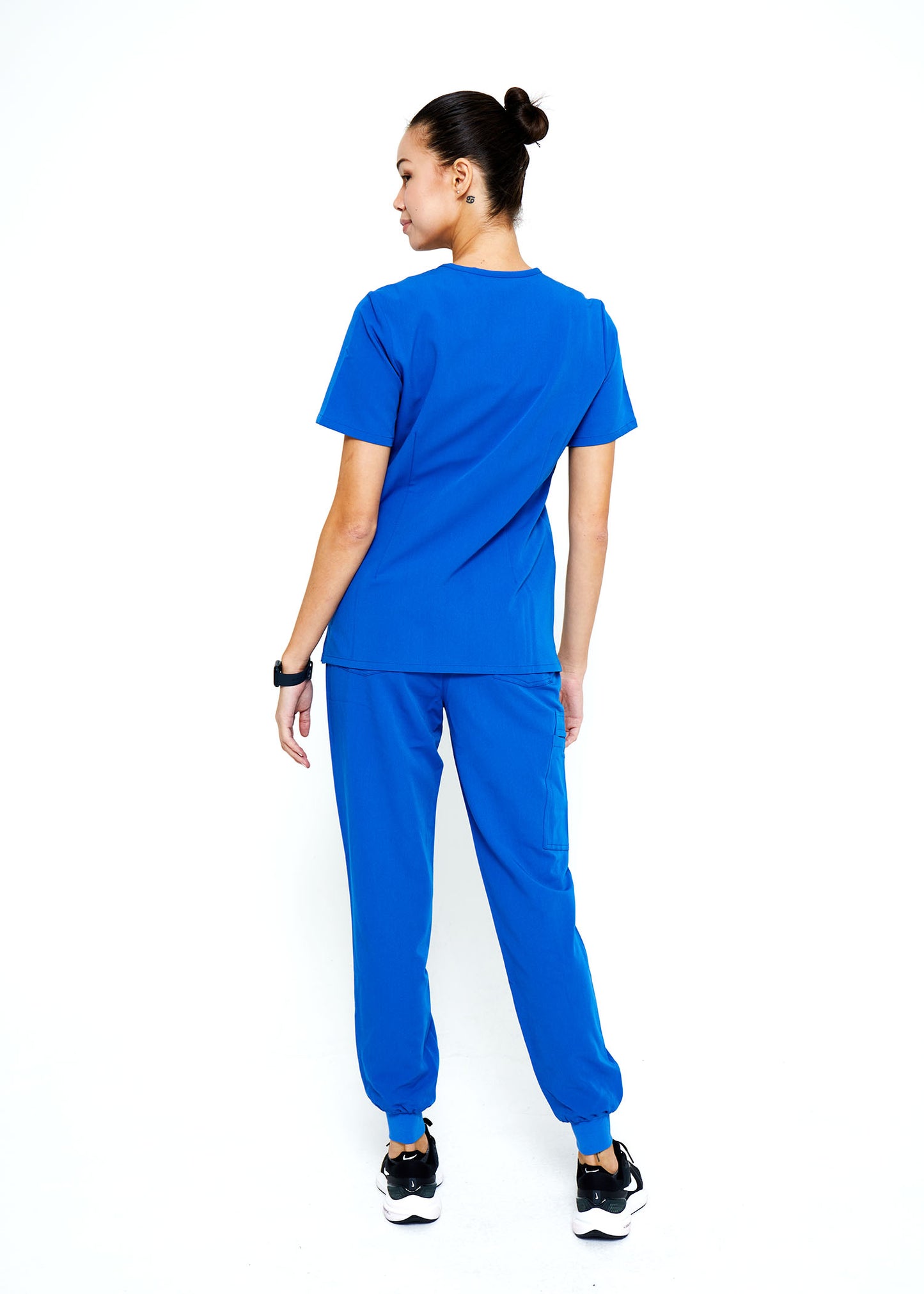 Model wearing scrubs.